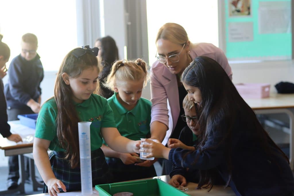 Teacher and Pupils in Science Lesson